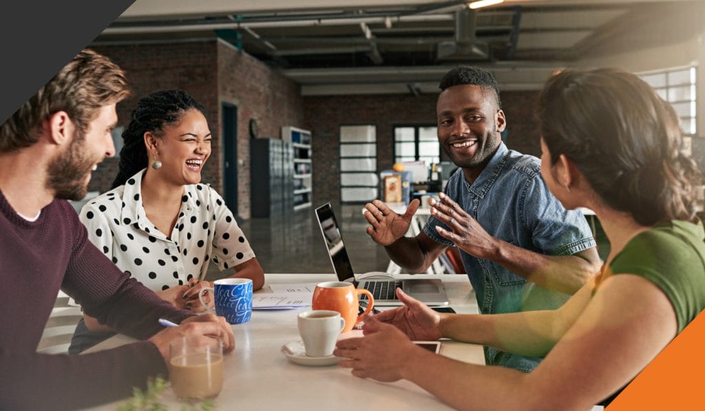 four co-workers gathered in a meeting room seated call timeout to reset