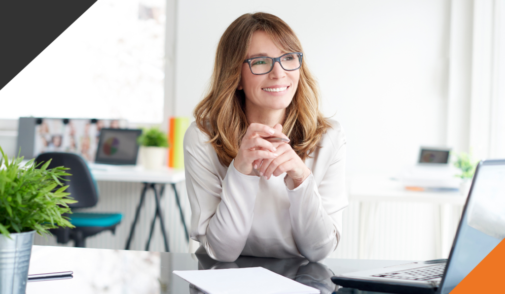 woman seated at desk in an office adopting tips of how be aware of your thought