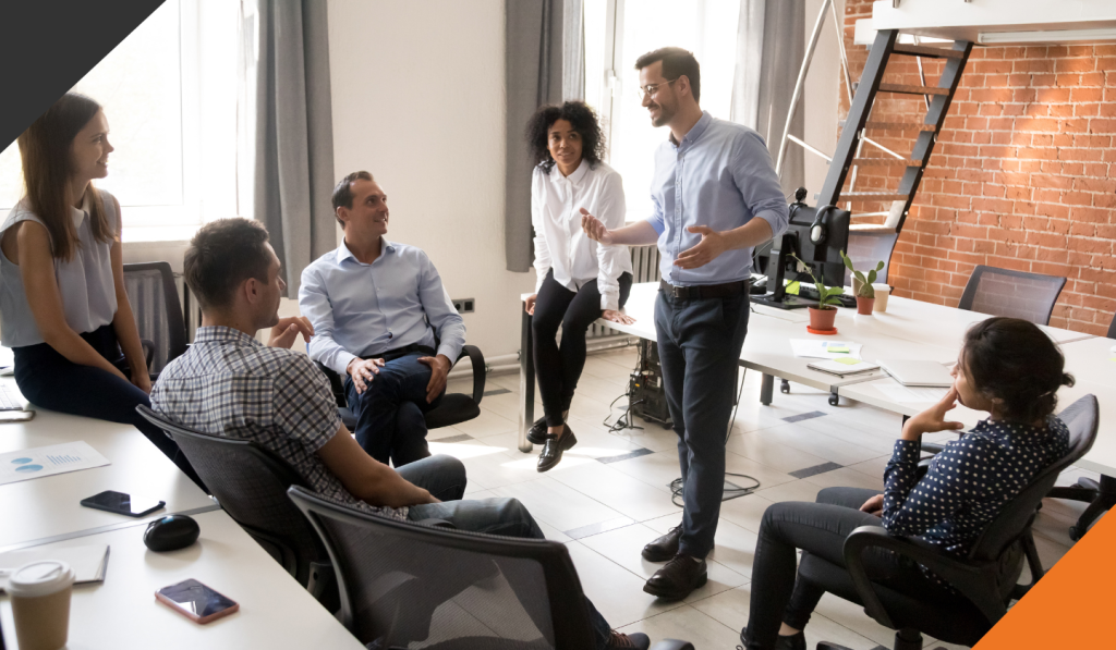 six co-workers in a meeting room in leadership training and coaching to create mental clarity