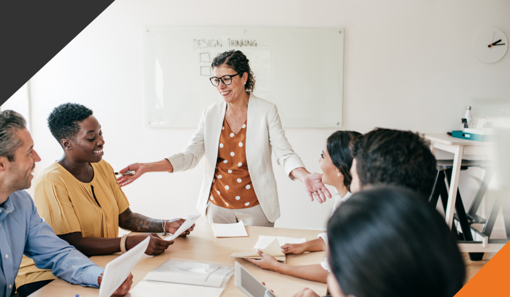 employees in a meeting room seated at a table with the manager discussing how to make the job of change much easier