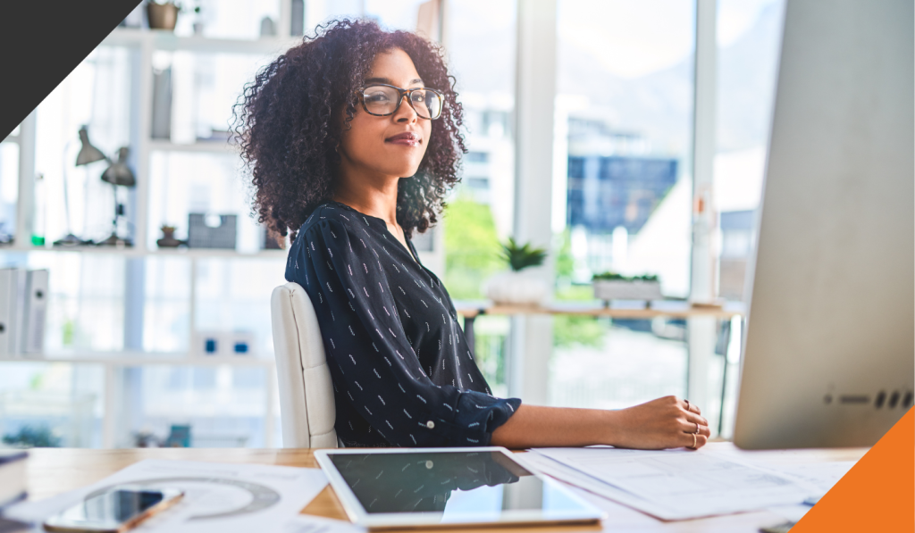a woman seated at a desk in an office contemplating how to create resilient goals