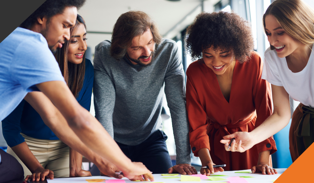 5 people from culturally diverse backgrounds in an office setting all implementing their diverse perspective
