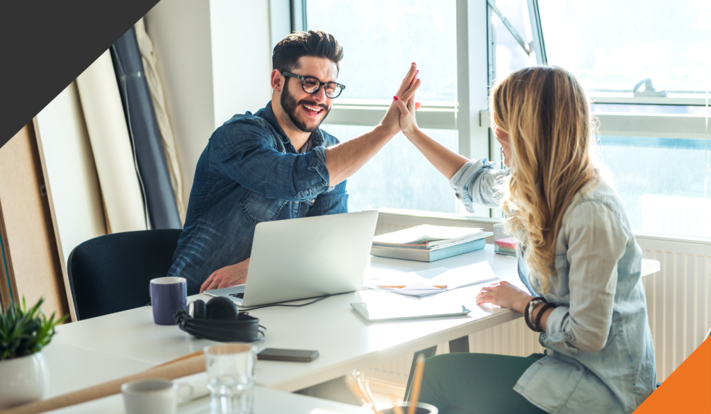 employees giving each other a high five for positive conversations