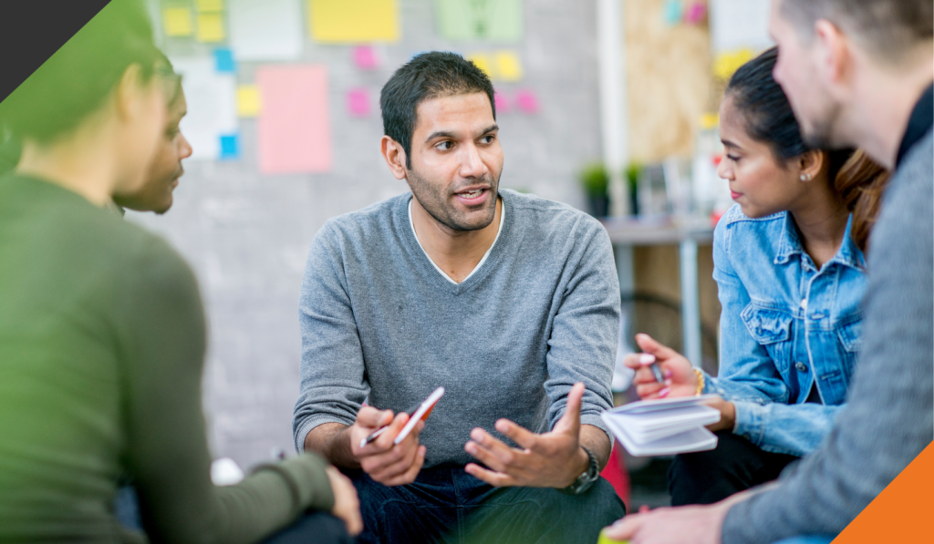 5 people seated in a circle in an office setting agreeing on how self-awareness can improve your leadership 