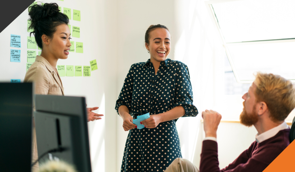 3 employees using sticky notes to plan end-to-end 